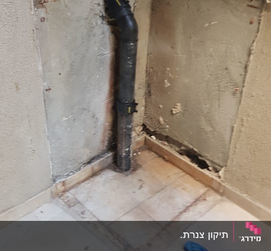 צינור ביוב שחור מותקן בקיר חשוף